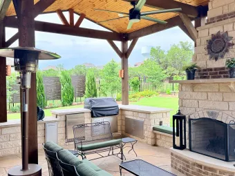 Outdoor living pavilion interior with ceiling fan, wood-beam ceiling, and outdoor kitchen in Austin, TX