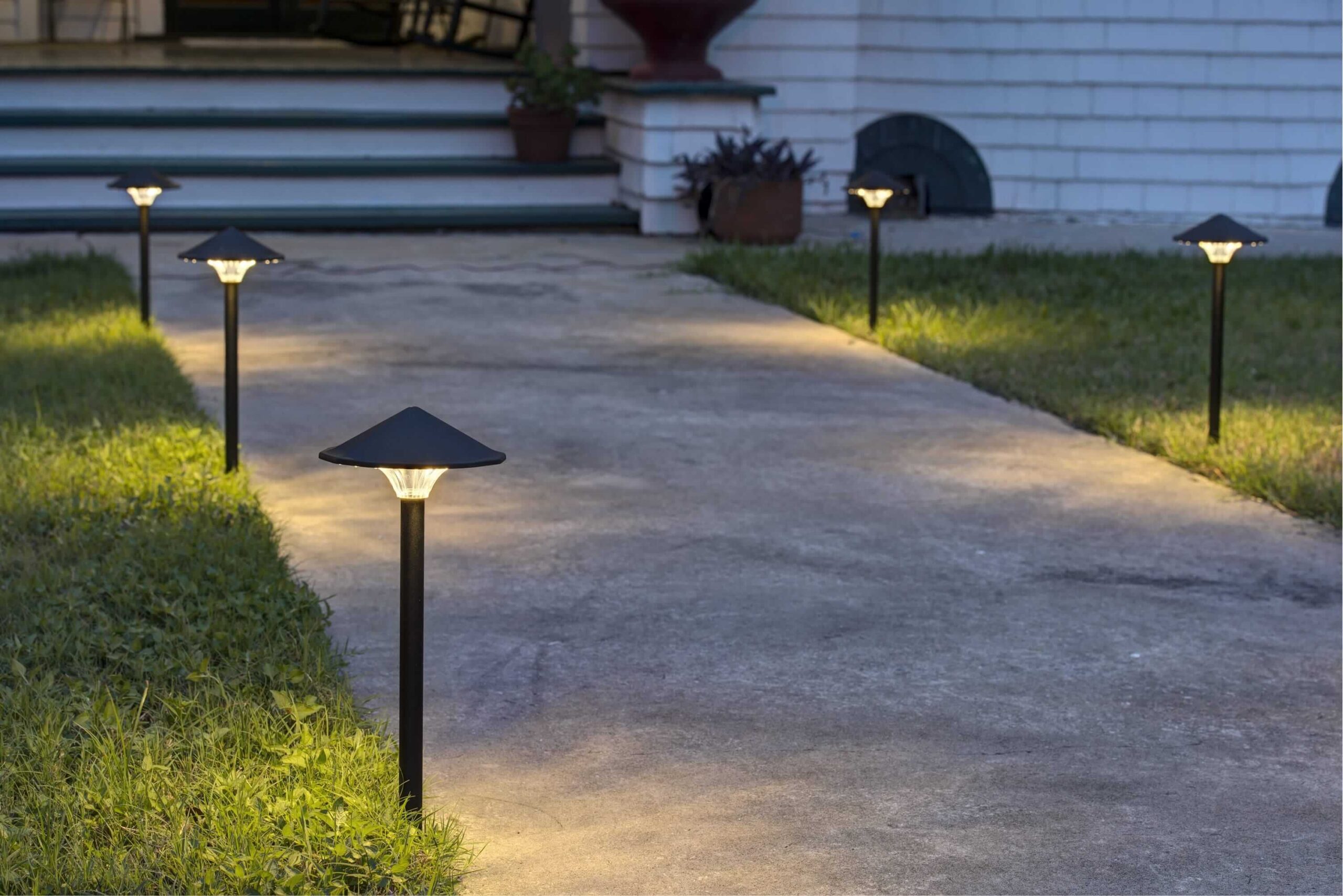 Evenly spaced pathway lights enhance home security and ambience, showing how landscape lighting improves curb appeal at night.