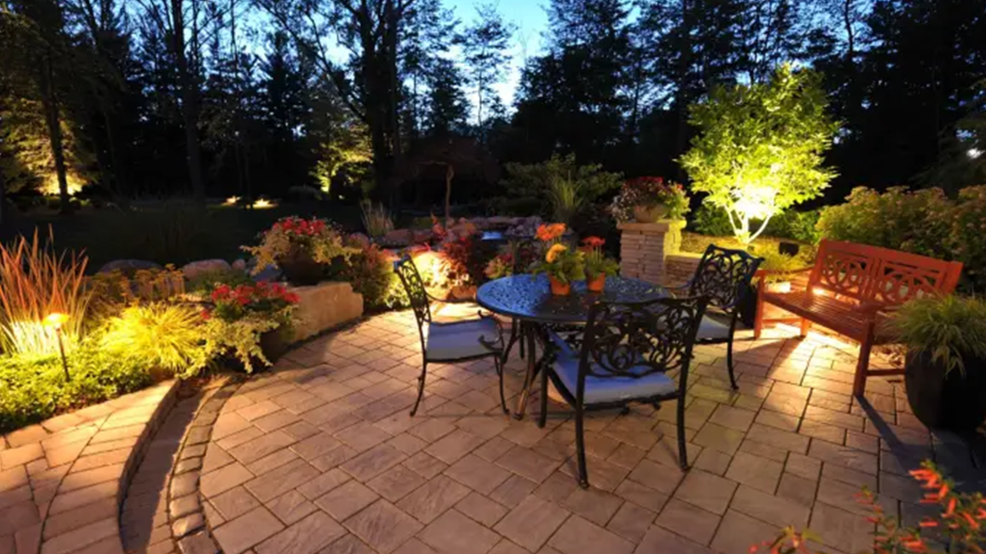 ornate garden table set up and landscape lighting