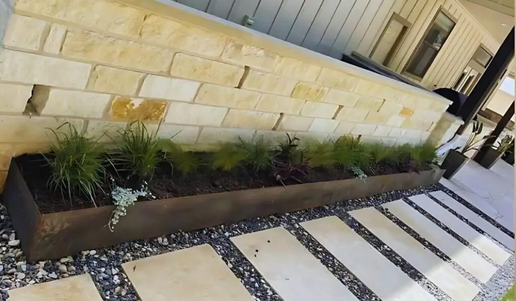 Modern Patio Design with custom planters and stylish outdoor space designed by Austin landscaping experts.