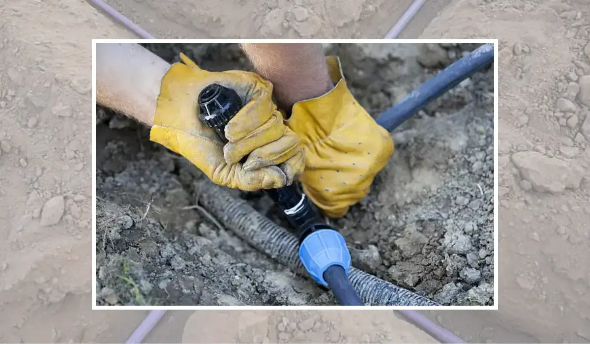 Close-up of a professional irrigation system installation process, showcasing hands securing irrigation pipes to ensure proper water flow and distribution.
