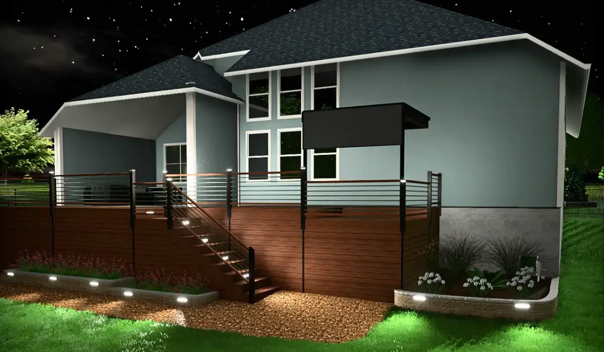 Backyard deck with stair lighting, ground lights, and flower bed uplights installed along the perimeter.