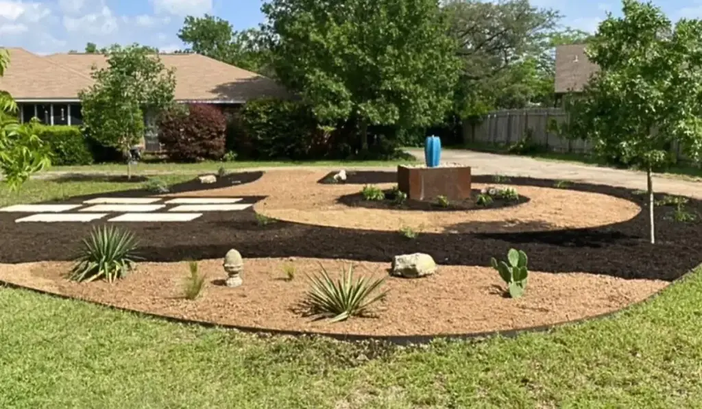 Smart landscaping design with drought-tolerant plants, mulch zones, and water-efficient layout for an Austin front yard.