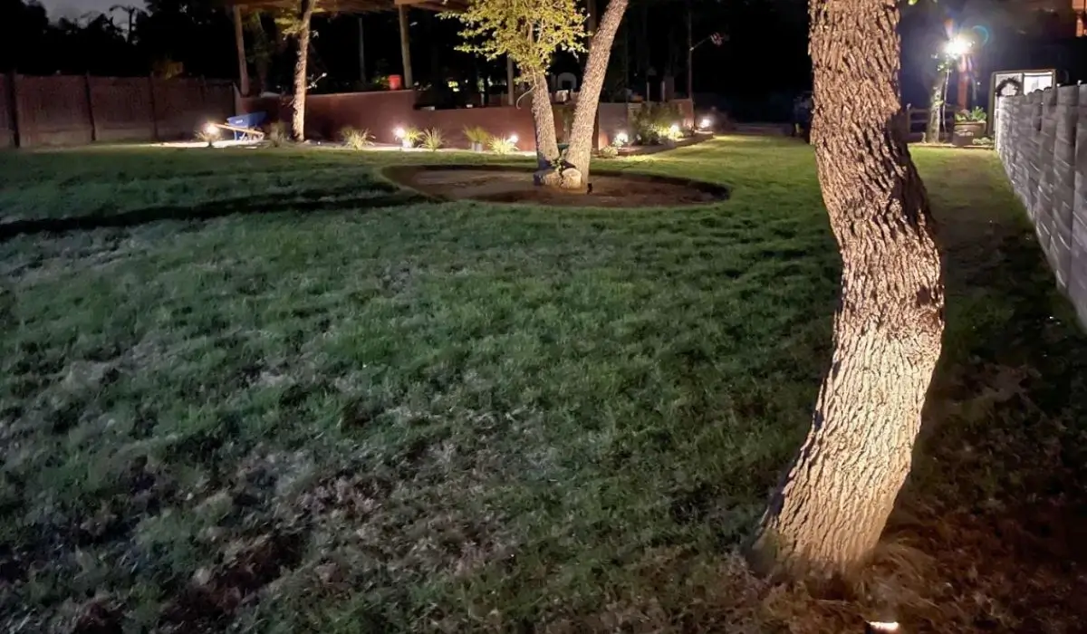 Backyard makeover in Austin featuring composite deck, stone fire pit, and stamped concrete patio for functional outdoor living.