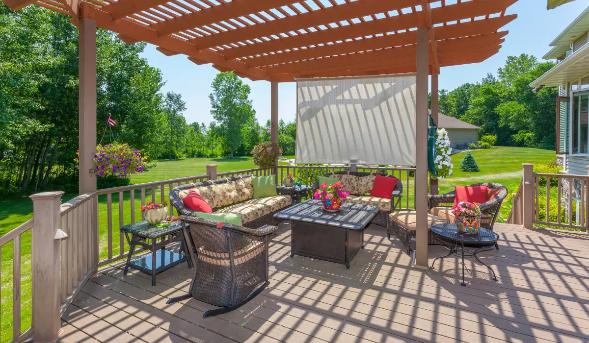 Landscaping for privacy with deck pergola, pull-down shade, and garden seating for backyard comfort.